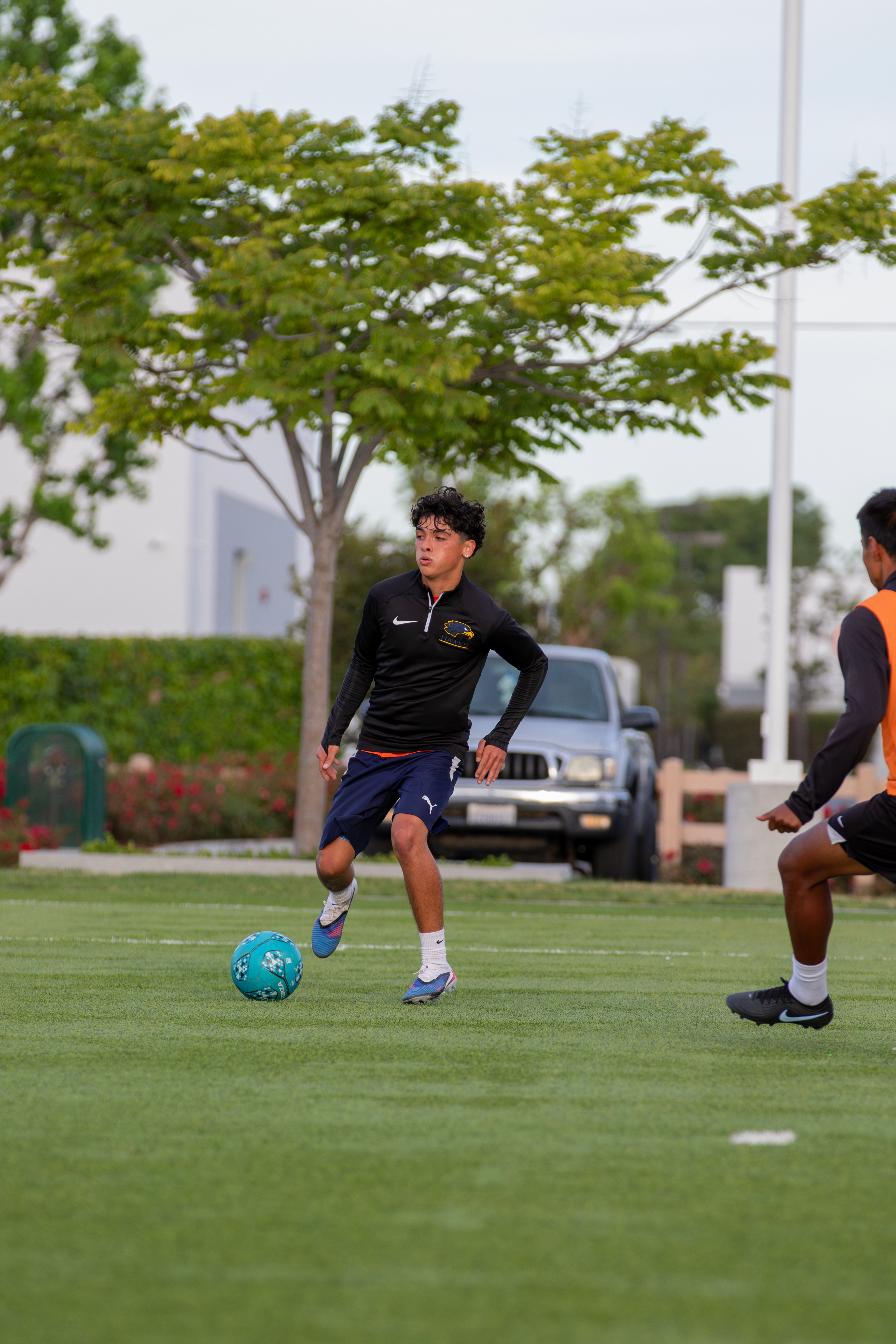 Player dribbling the ball past a defender